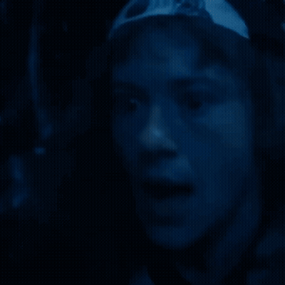 Close Up Face In Dark Room Blue Background GIF