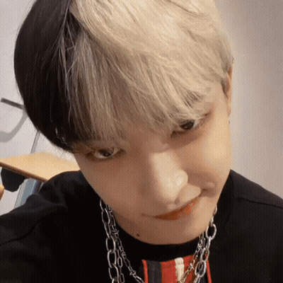 Close Up Face With Black And White Hair And Necklace GIF