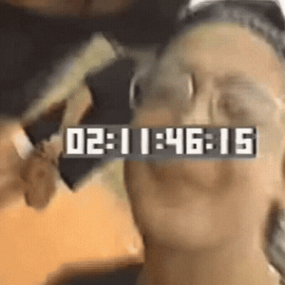 Close-Up Face With Clock Saying 02:11:46:15 GIF