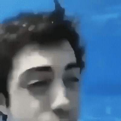 Close Up Face With Eyes Closed Against Blue Background GIF