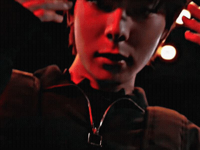 Close Up Face With Red Lights Behind GIF