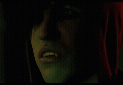 Close Up Face With Vampire Teeth GIF
