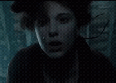 Close Up Face With Water Coming Out In Dark Room GIF