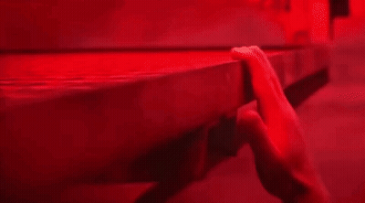 Close-Up Hand On Table In Red Light GIF