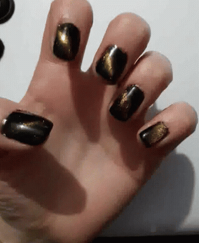 Close Up Hand With Black And Gold Nail Polish GIF