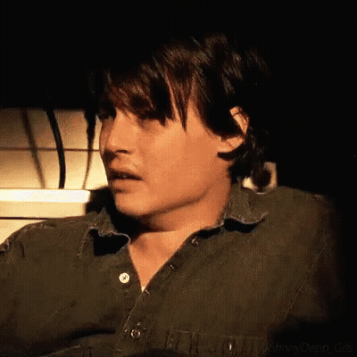 Close Up Man In Green Shirt Dark Room GIF