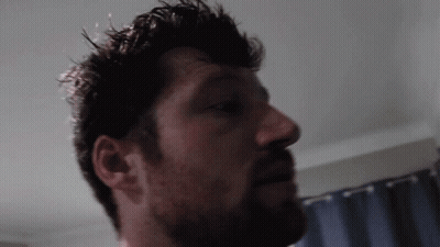 Close Up Man With Beard And Blue Curtain GIF