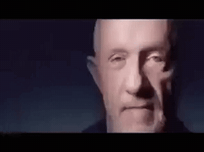 Close Up Man With Beard Looking At Camera In Dark Room GIF