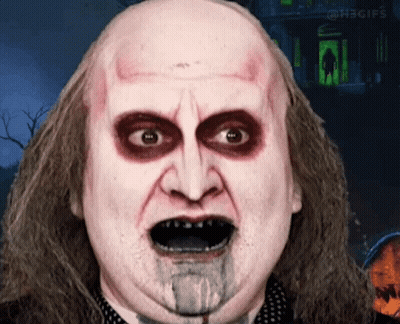 Close Up Man With Blood Coming Out Of Mouth In Front Of Haunted House GIF