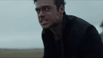 Close Up Man With Glowing Eyes In Field GIF