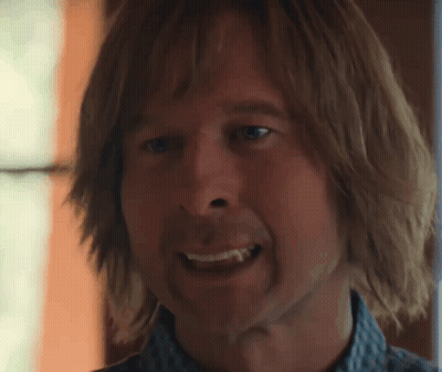 Close Up Man With Long Hair Showing Tooth GIF