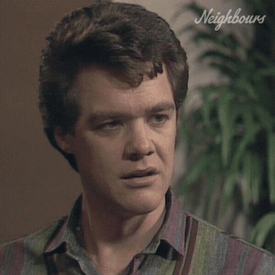 Close Up Man With Neighbours Written On Wall GIF