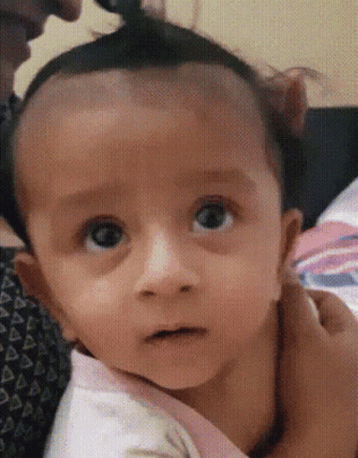 Close Up Of Baby Face Held By Woman GIF