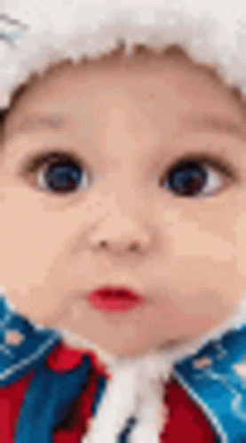 Close Up Of Baby Wearing Santa Hat And Red And Blue Jacket GIF