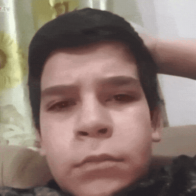 Close Up of Boy With Hand on Head