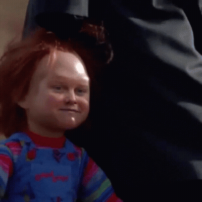 Close-Up Of Child's Doll With Red Hair And Overalls GIF