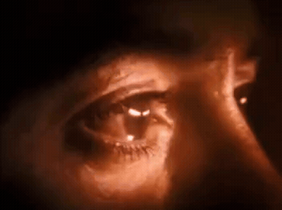 Close Up of Eye With Light Shining Through in Dark Room