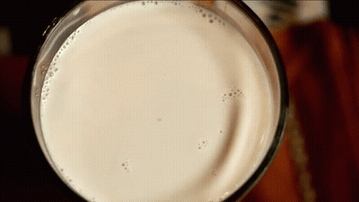 Close Up Of Glass Of Milk With Bubbles GIF