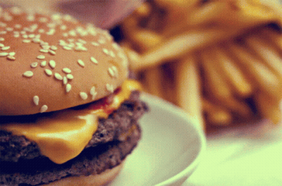 Close Up Of Hamburger With Sesame Seeds And French Fries GIF