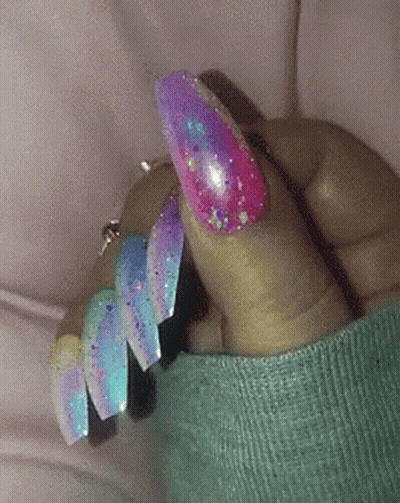 Close-Up Of Hand With Blue Nails And Silver Glitter GIF
