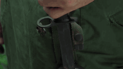 Close Up Of Hands Holding Green Bag GIF