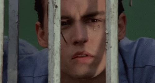 Close Up Of Man Behind Bars With Tear Running Down Face GIF