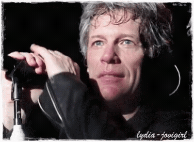 Close Up Of Man Holding Microphone With Lydia GIF