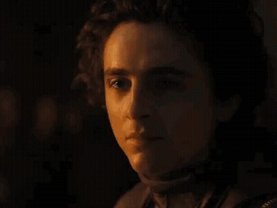 Close-Up Of Man Holding Stick In Dark Room GIF