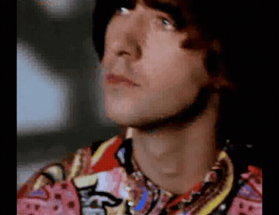 Close Up Of Man In Colorful Shirt Looking Up GIF