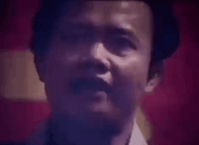 Close Up Of Man's Face Against Red Background GIF