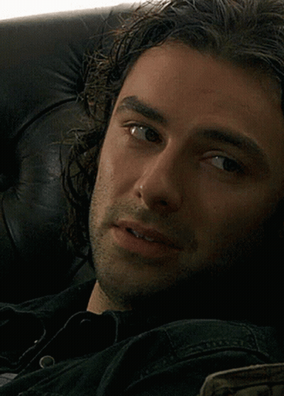 Close Up Of Man's Face In Black Shirt GIF