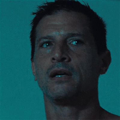 Close Up Of Man's Face In Dark GIF