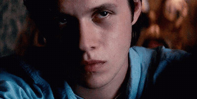 Close Up Of Man's Face In Dark Room GIF