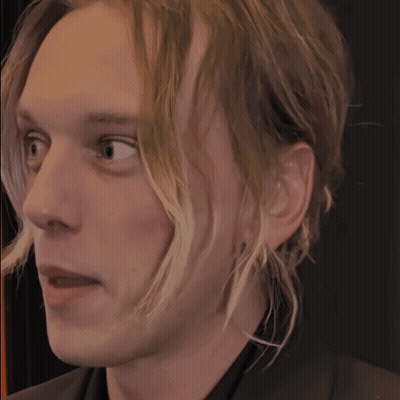 Close Up Of Man's Face On Black Background GIF
