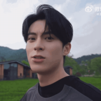 Close Up Of Man's Face With Chinese Writing GIF