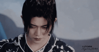 Close Up Of Man's Face With Chinese Writing GIF