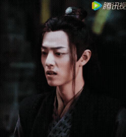 Close Up Of Man's Face With Chinese Writing GIF