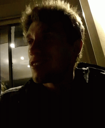 Close Up Of Man's Face With Dark Background GIF
