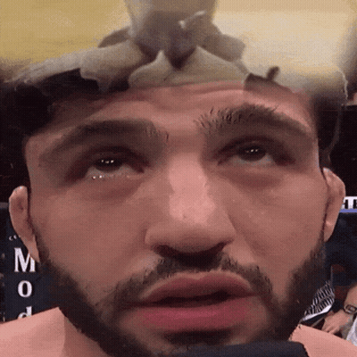 Close Up Of Man's Face With Letter M GIF