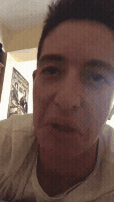 Close Up Of Man's Face With Poster GIF