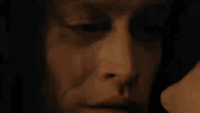 Close Up Of Man's Face With Woman Behind GIF