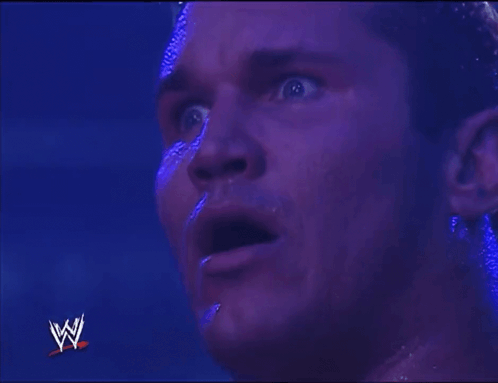 Close Up Of Man's Face With Wrestling Logo GIF