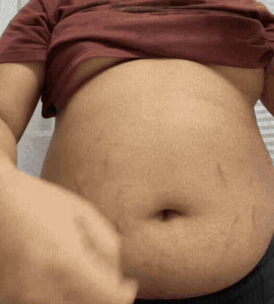 Close Up Of Man's Stomach In Red Shirt GIF