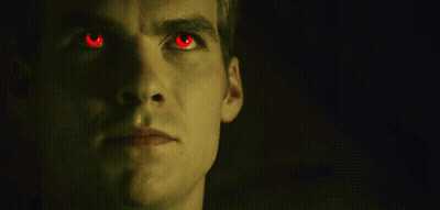 Close Up Of Man With Red Eyes In The Dark GIF