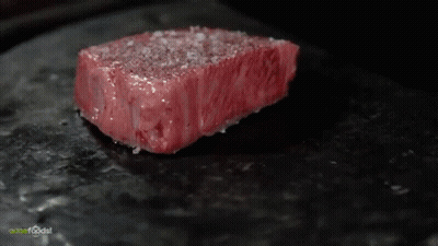 Close Up Of Meat On Black Plate Questfoods GIF