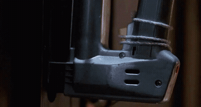 Close Up Of Nail Gun On Wall GIF