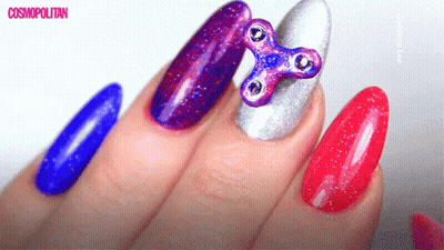 Close Up Of Nails With Fidget Spinner GIF