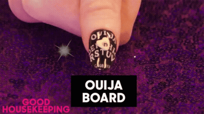 Close Up Of Nails With Ouija Board GIF