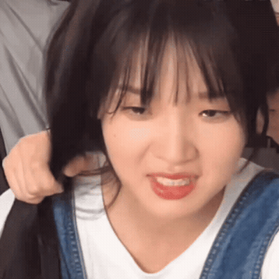 Close Up Of Person Holding Hair And Making Funny Face GIF