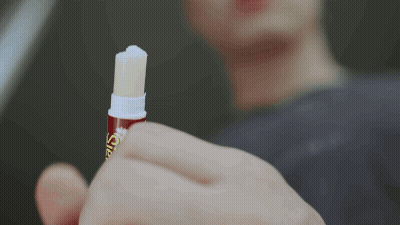 Close Up Of Person Holding Lip Balm Saying Lip Balm GIF
